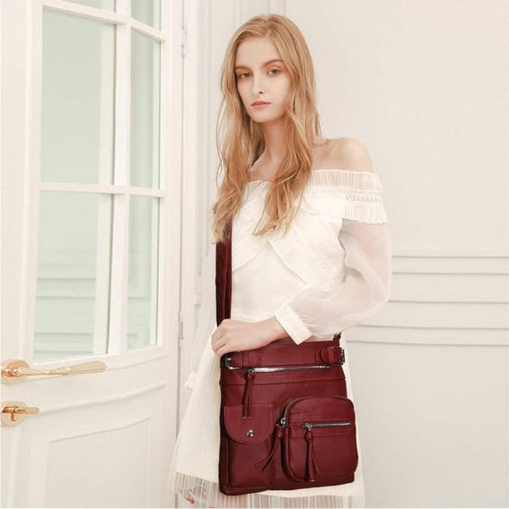 Secure women's crossbody travel bag with multiple compartments for organized storage.