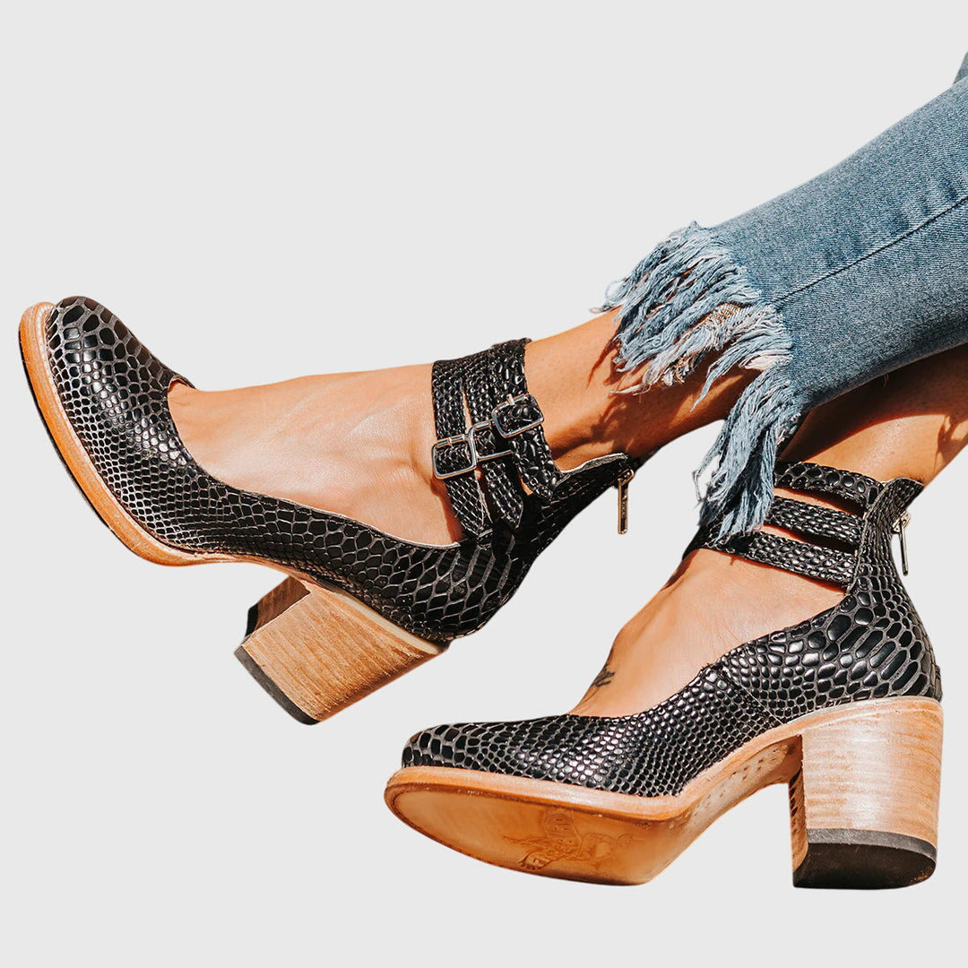 Women's stylish black ankle boots with buckle straps, block heel, and cutout design, perfect for fall fashion.