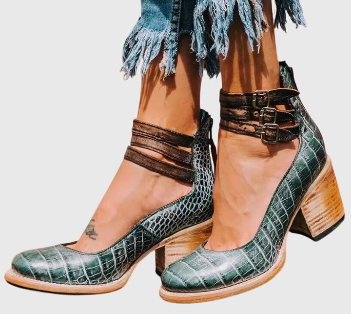 Must-have women's fall boots: stylish black ankle boots, block heel, cutout design, and buckle strap embellishments.