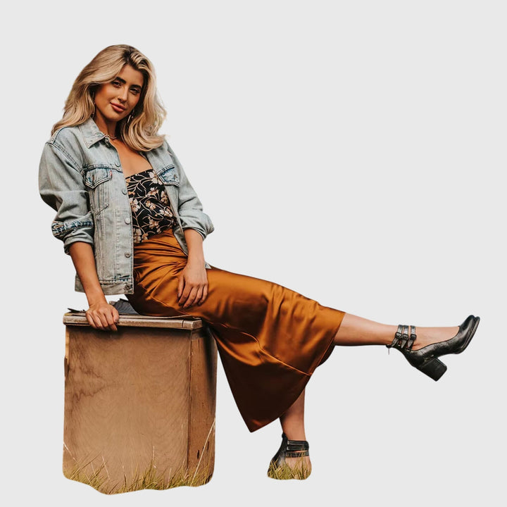 Fashionable women's cutout ankle boots featuring a chunky block heel and edgy buckle straps, western style.