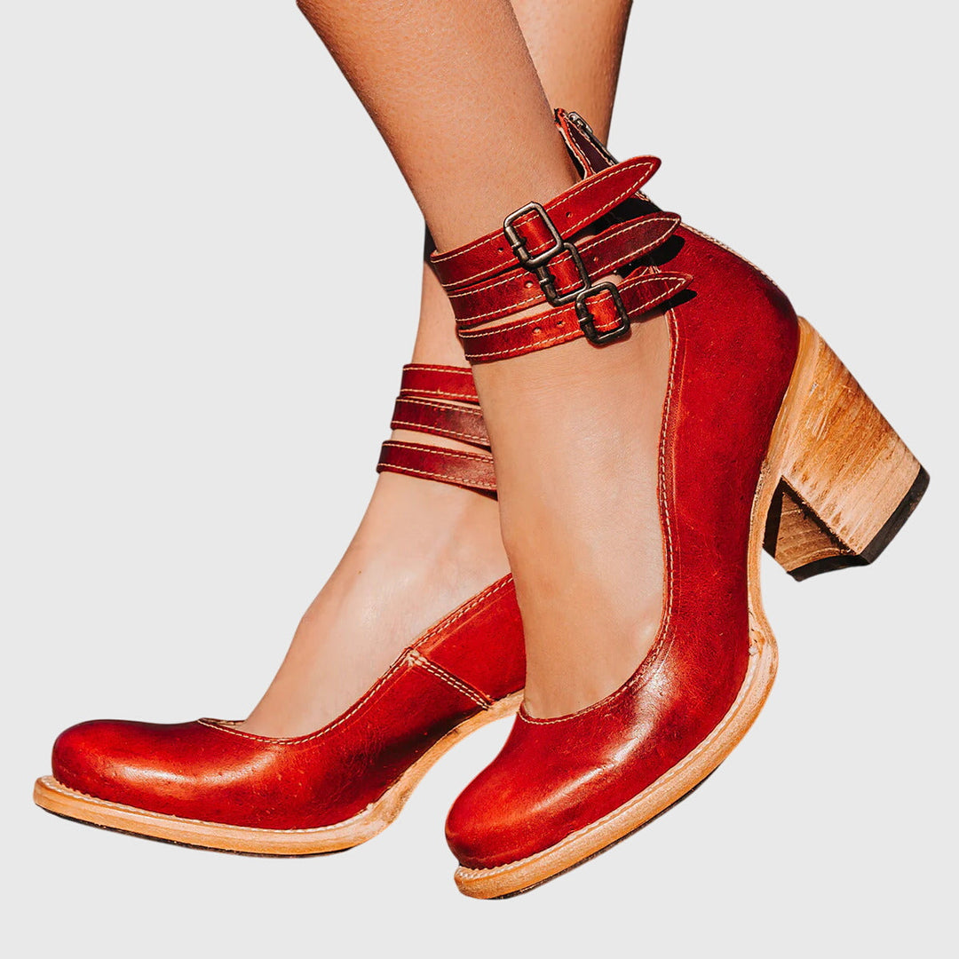 Statement women's ankle boots, black, with a sturdy block heel, multiple buckle straps, and trendy cutout design.