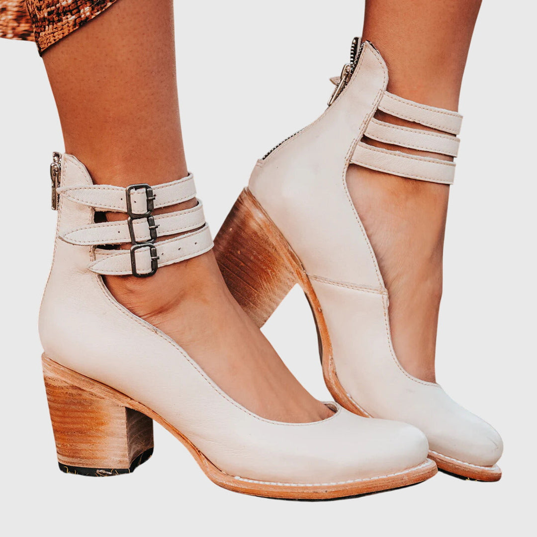 Versatile women's fashion boots: elegant black ankle boots, block heel, cutout details, and stylish buckle accents.