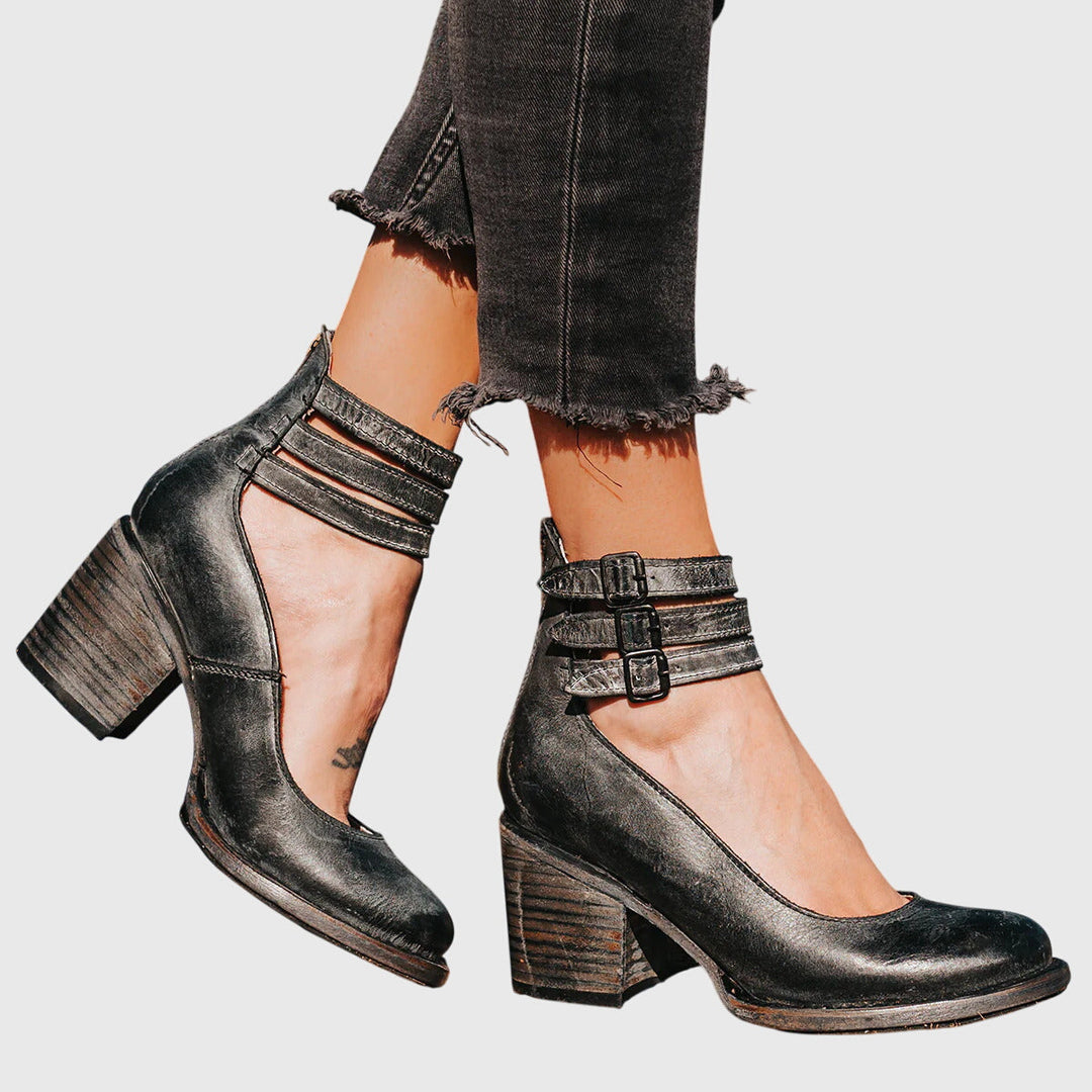 Elevate your look with these women's black block heel boots, designed with stylish buckle straps and unique cutouts.