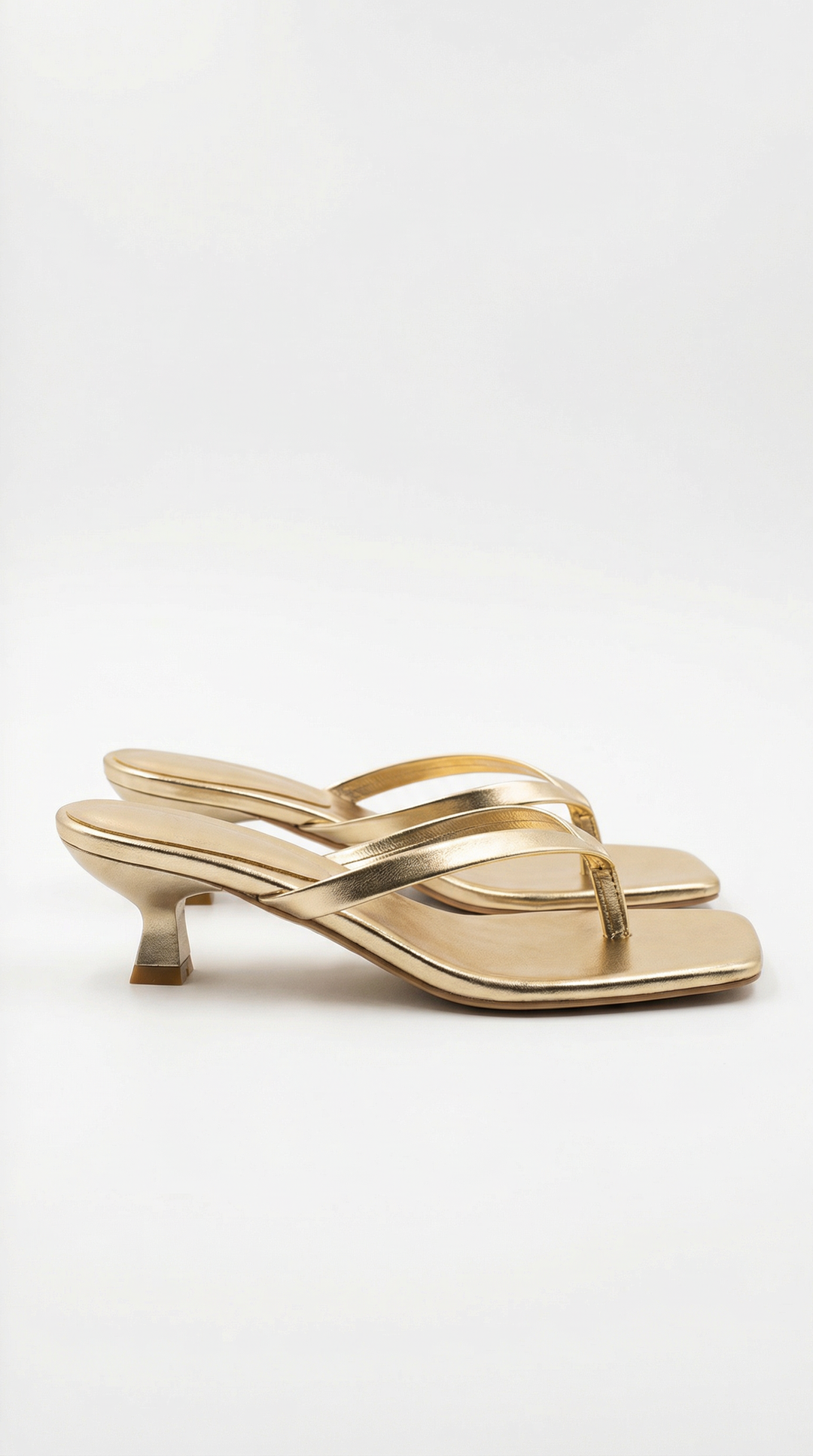 Comfortable slip-on thong sandals with a chic kitten heel for women.