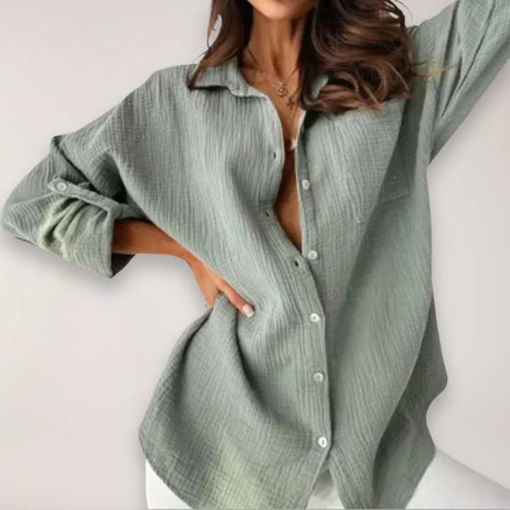 Chic women's button-up shirt featuring roll-up sleeves; a versatile top for both office and casual outfits.