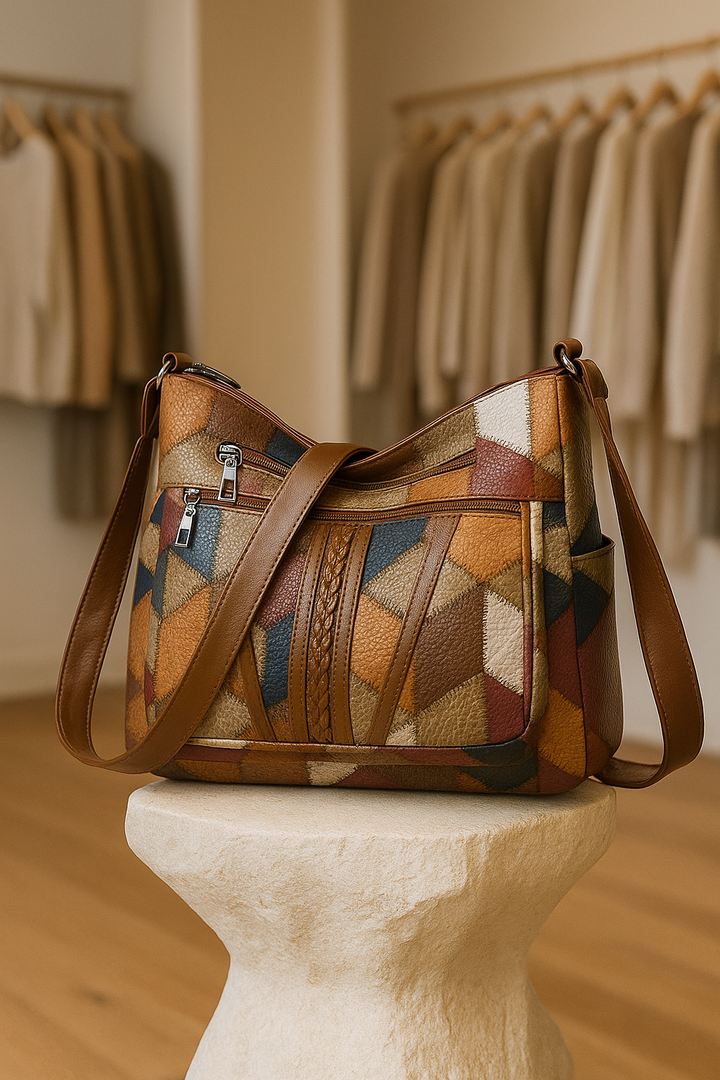 Women's stylish geometric patchwork handbag, vegan leather. A chic fashion accessory.