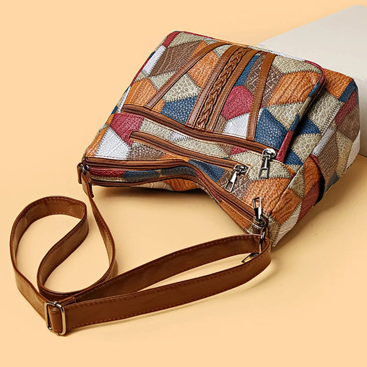 Front view of a women's geometric patchwork vegan leather handbag. Chic & trendy.