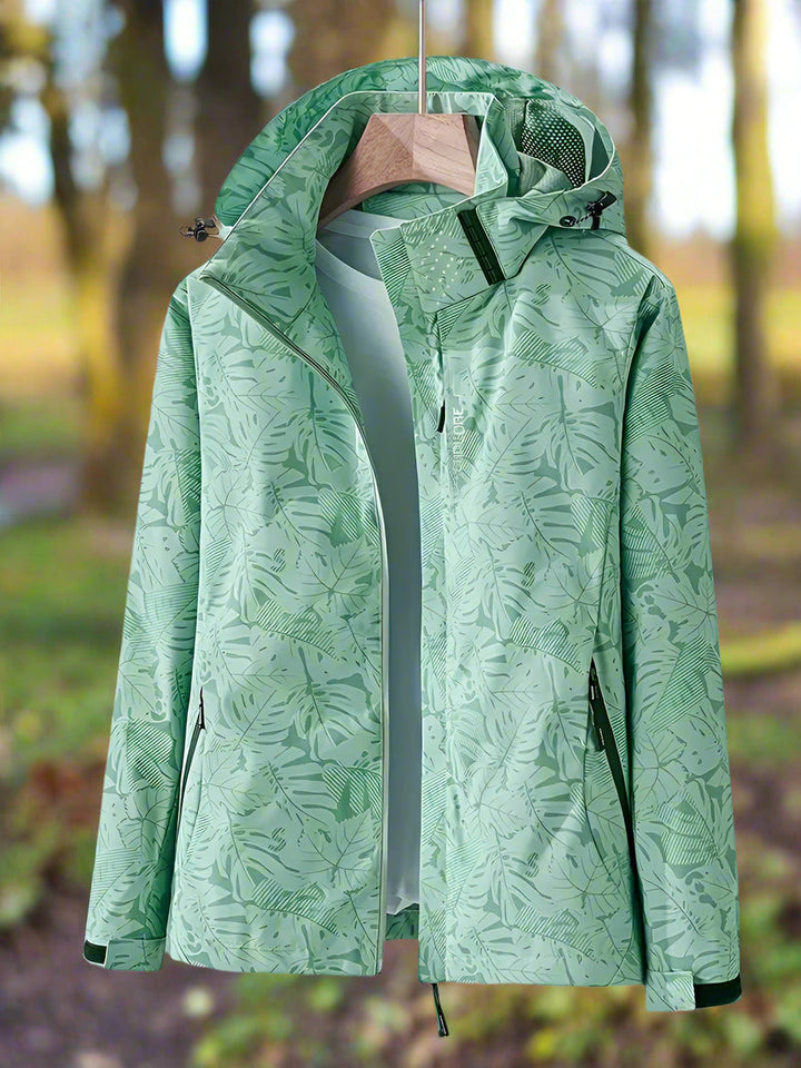 Women's stylish lightweight waterproof rain jacket with a subtle leaf pattern, perfect for summer travel.