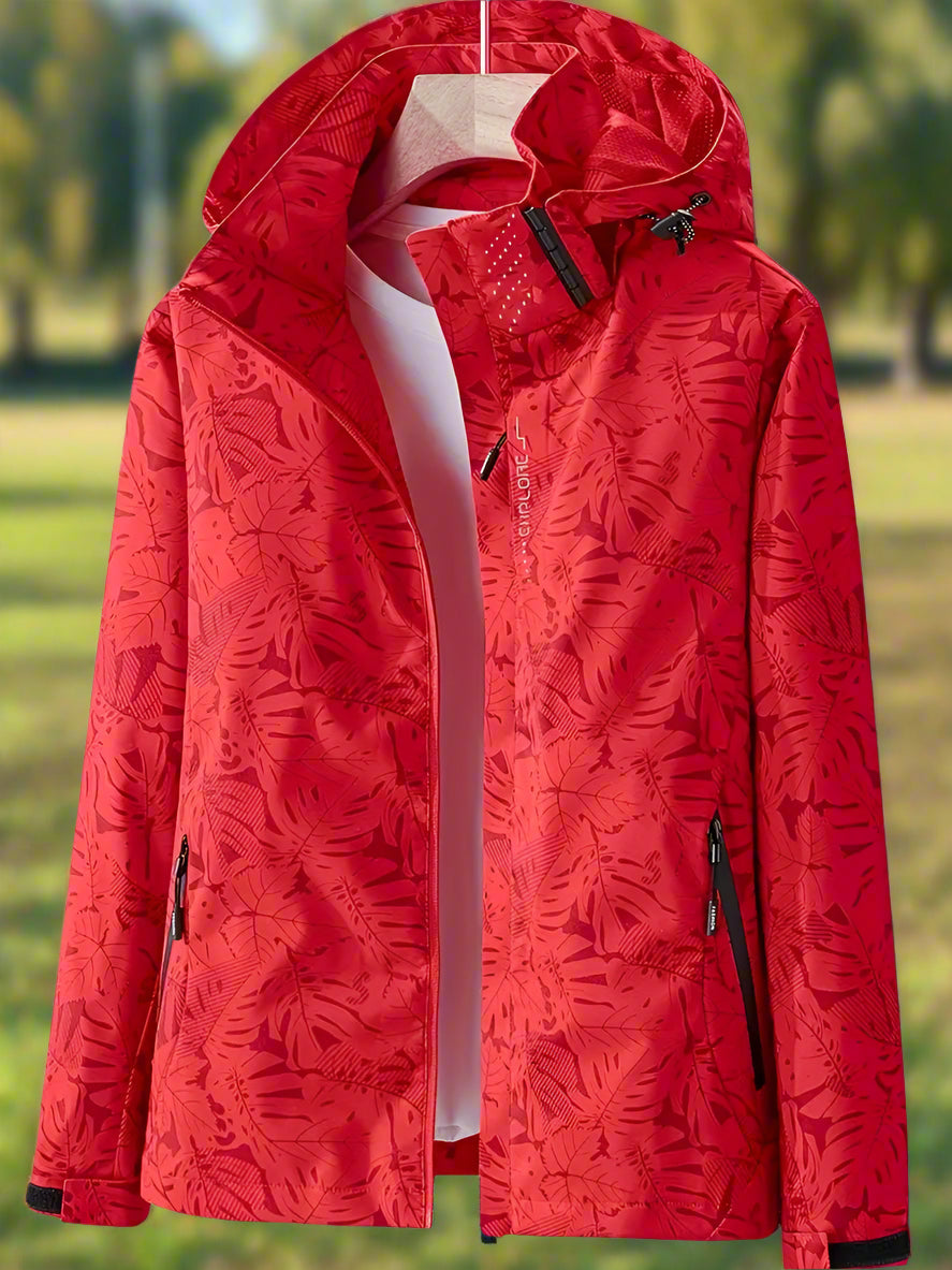 Breathable women's summer rain jacket, waterproof & windproof with adjustable hood & cuffs. Leaf print design.