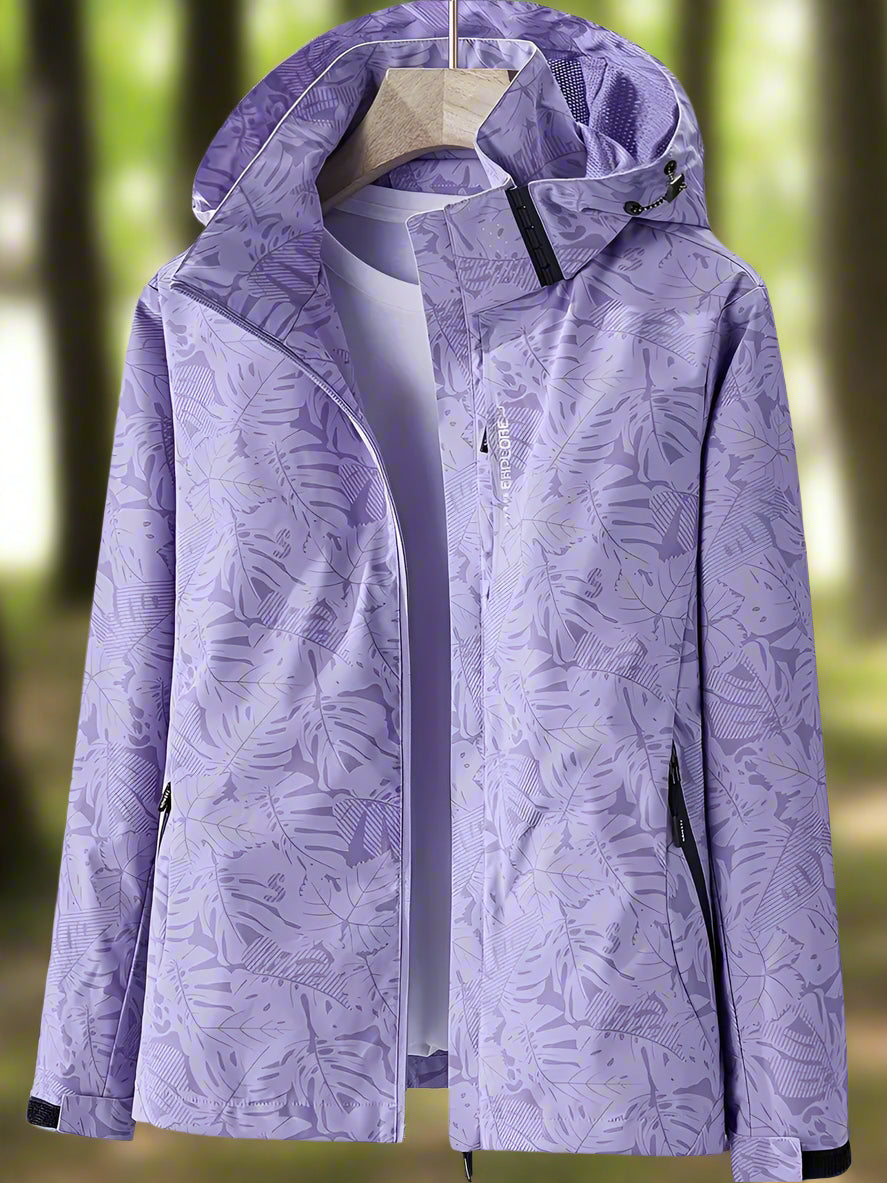 Close-up of women's waterproof summer jacket, showing lightweight fabric and subtle leaf pattern detail.