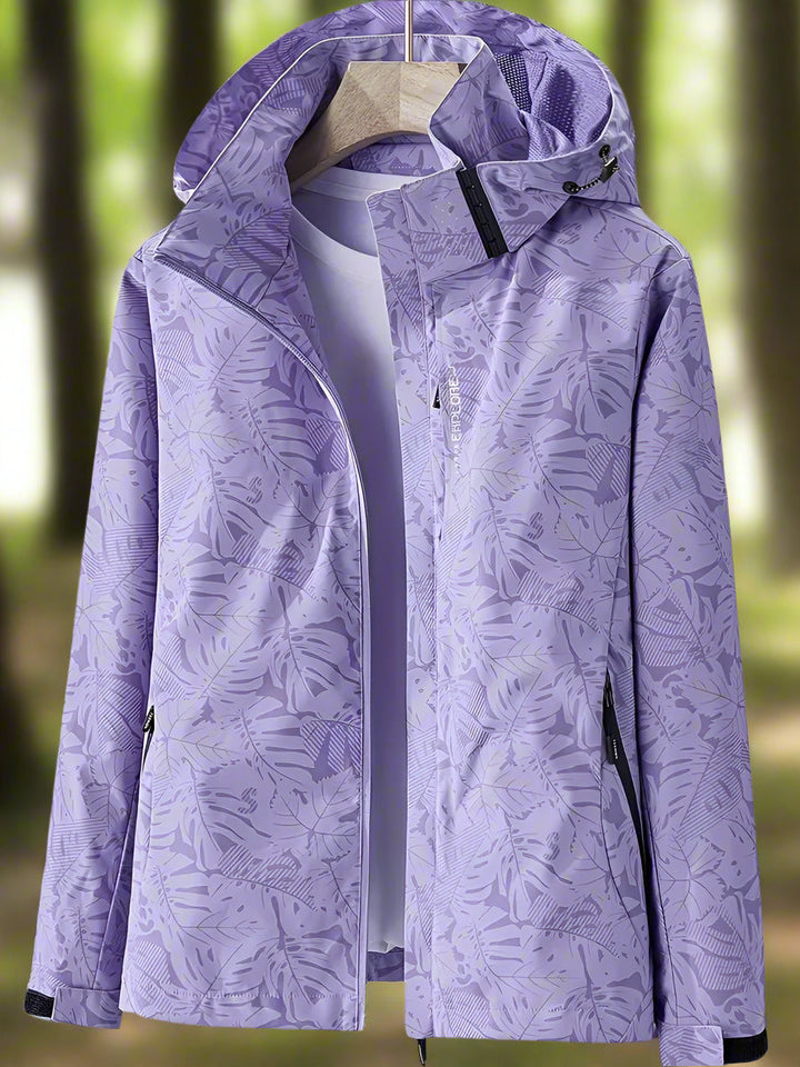 Close-up of women's waterproof summer jacket, showing lightweight fabric and subtle leaf pattern detail.