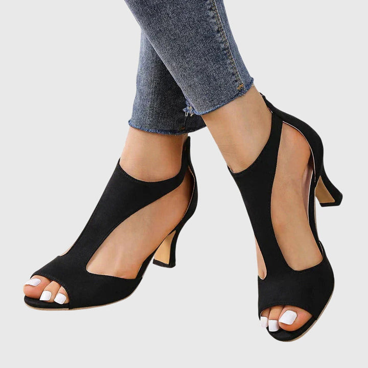 Comfortable pink women's peep toe sandals, featuring elegant cut-outs & a chic block heel design.