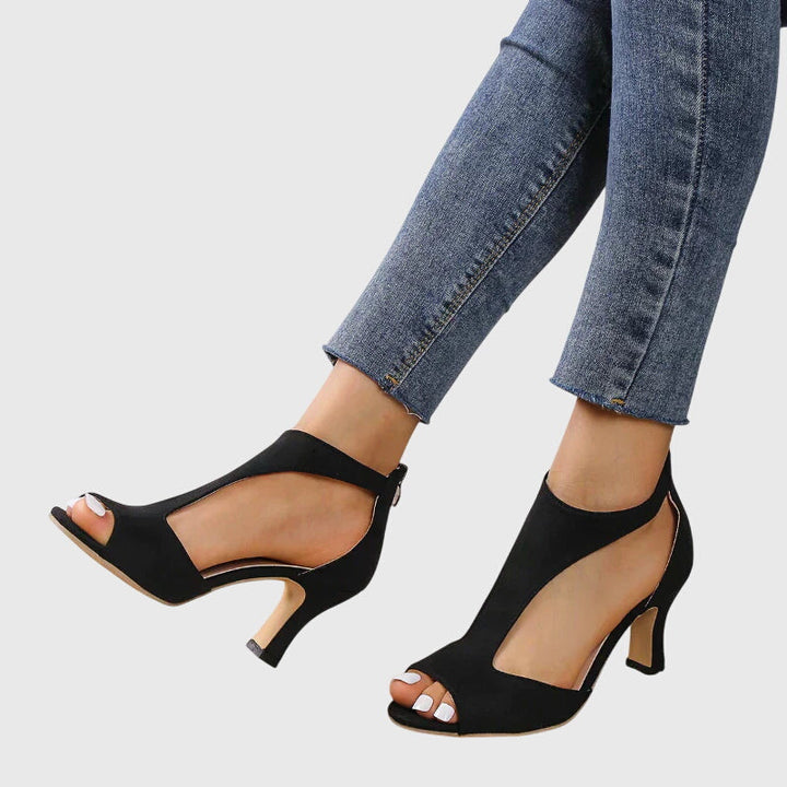 Stylish pink women's block heel sandals, featuring a peep toe and trendy cut-out design for fashion.