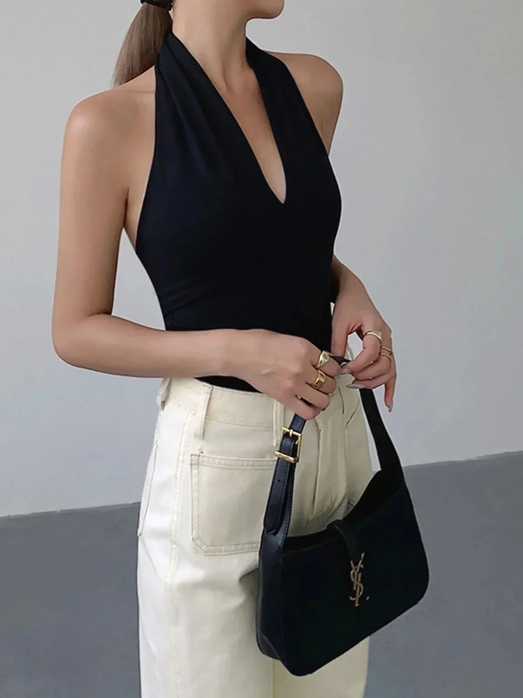 Chic women's halter top, sleeveless with a modern crossover V-neck. Versatile for daily & summer outfits.