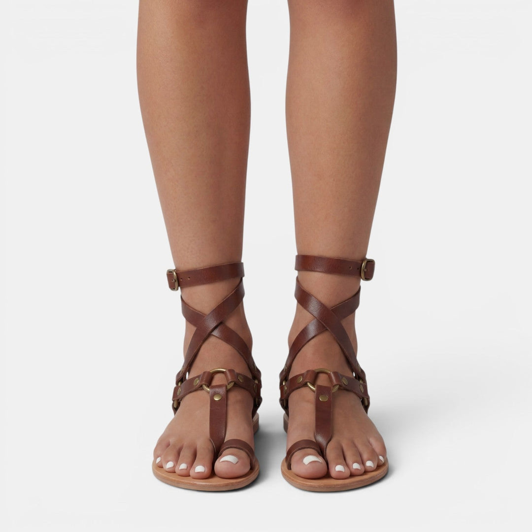 Trendy women's flat sandals featuring a chic snake print design & comfortable crossover straps for all-day wear.