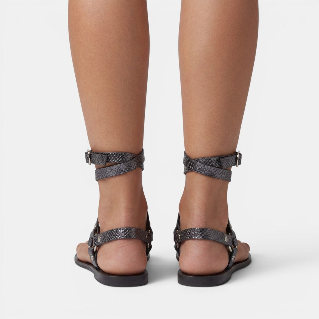 Comfortable & trendy women's flat sandals: snake print, crossover straps, buckled, perfect for summer fashion.