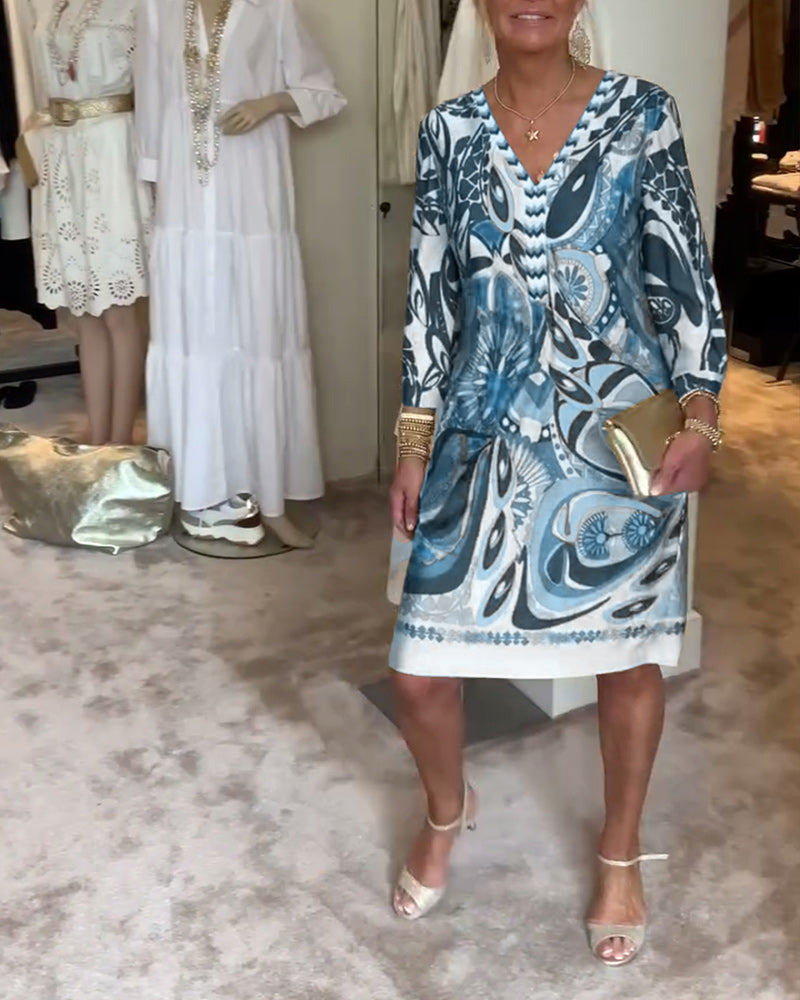 Flowy women's boho tunic dress in a vivid sunburst print, ideal for resort wear & comfort.