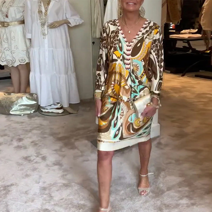 Chic women's sunburst print tunic dress, embodying a comfortable retro summer style.