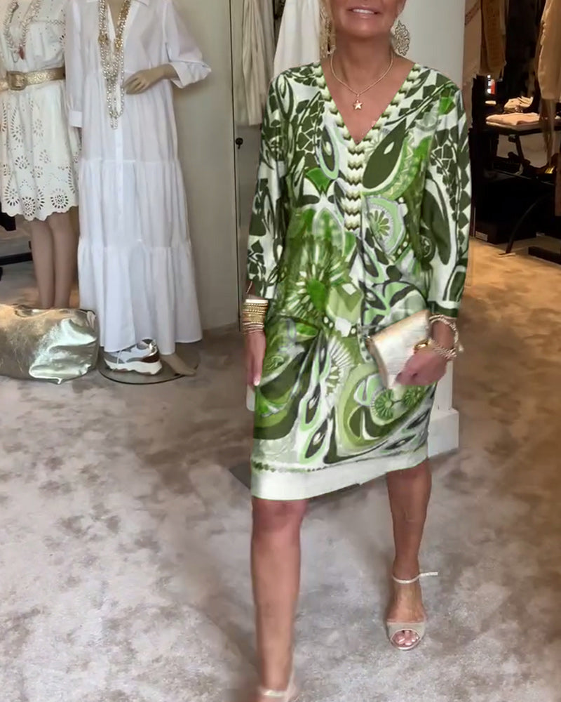 Woman wearing a flowing sunburst print boho tunic dress, perfect for a stylish vacation.