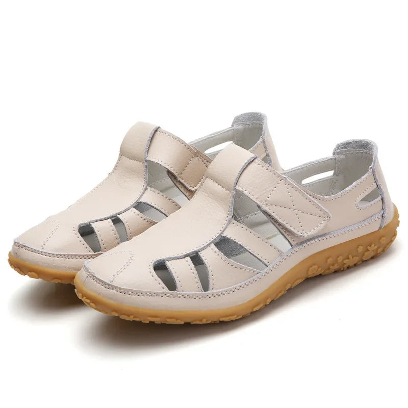 Model's foot wearing supportive open-toe women's sandals, showcasing summer style and comfort.