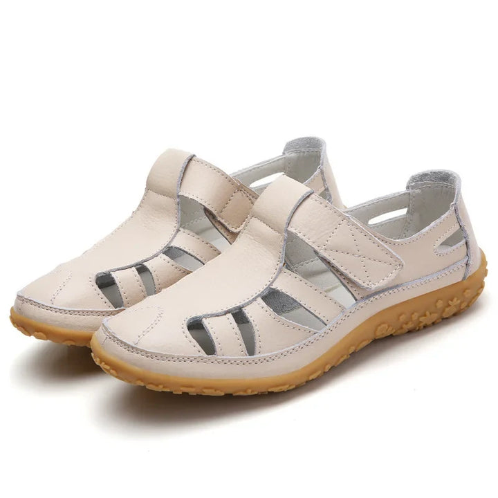 Model's foot wearing supportive open-toe women's sandals, showcasing summer style and comfort.