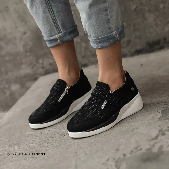 Supportive women's comfort sneakers, designed for daily wear with cushioned arch support and adjustable fit.