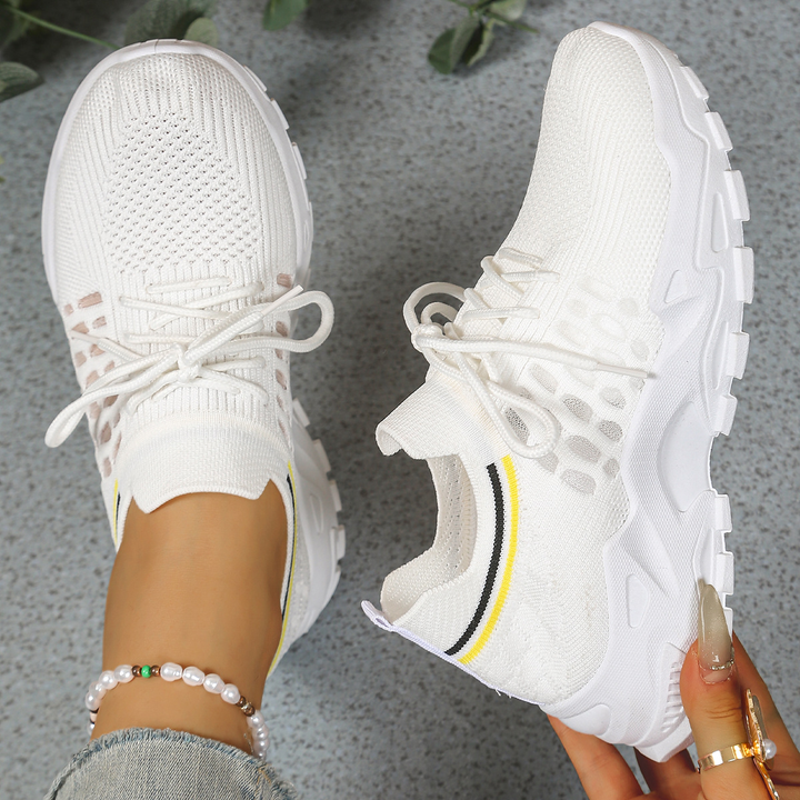 Supportive women's walking sneakers, lace-up style, offering cushioned comfort and orthopedic support.