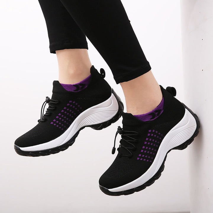 Cushioned women's sneakers providing ergonomic comfort and arch support.