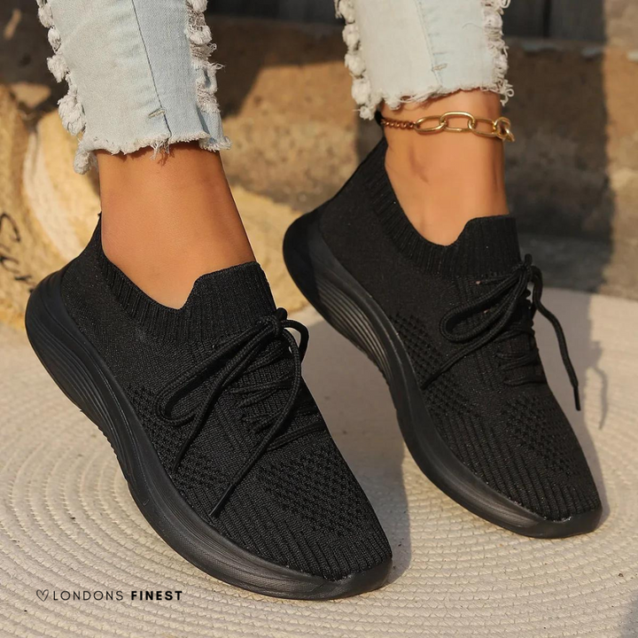 Comfortable gray women's walking sneakers with superior arch support and soft cushioning for all-day wear and activity.