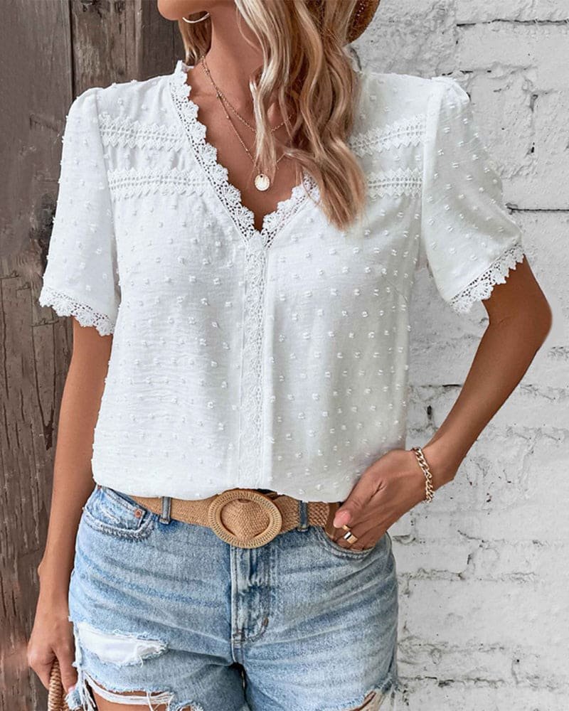 Bohemian style women's Swiss Dot V-neck top. Relaxed fit, short sleeve, and feminine lace trim.