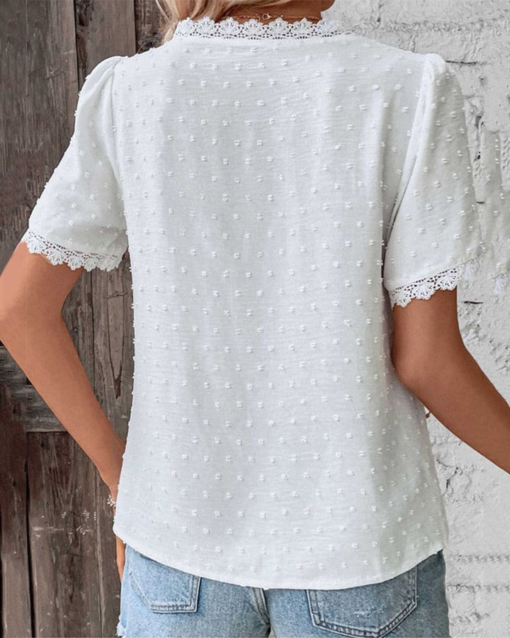 Textured Swiss Dot V-neck blouse for women. Short sleeve, lace trim, ideal for casual spring & summer fashion.