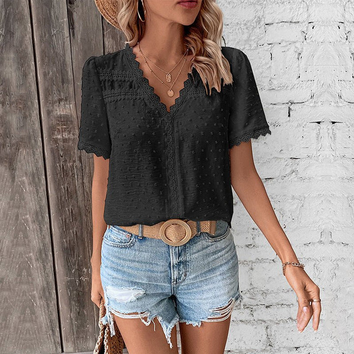 Feminine textured Swiss Dot V-neck blouse for women. Features short sleeves and delicate lace trim, bohemian style.