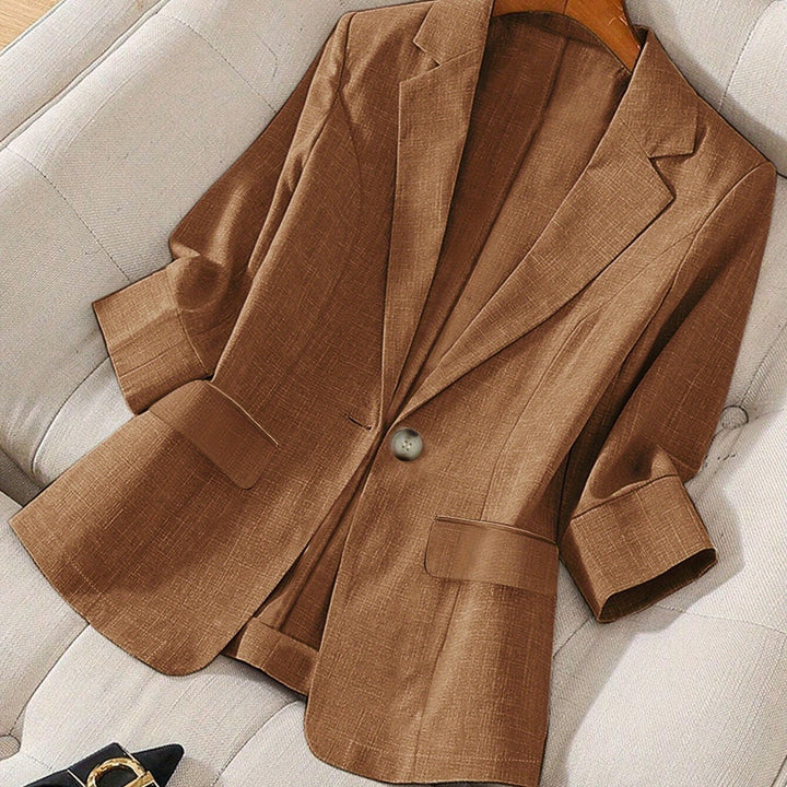 Dynamic shot of a woman in a lightweight tailored cropped blazer, showing fluid movement.