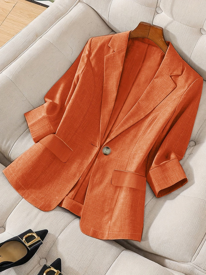 Stylish women's cropped blazer, back view. Modern tailored jacket with a chic design.