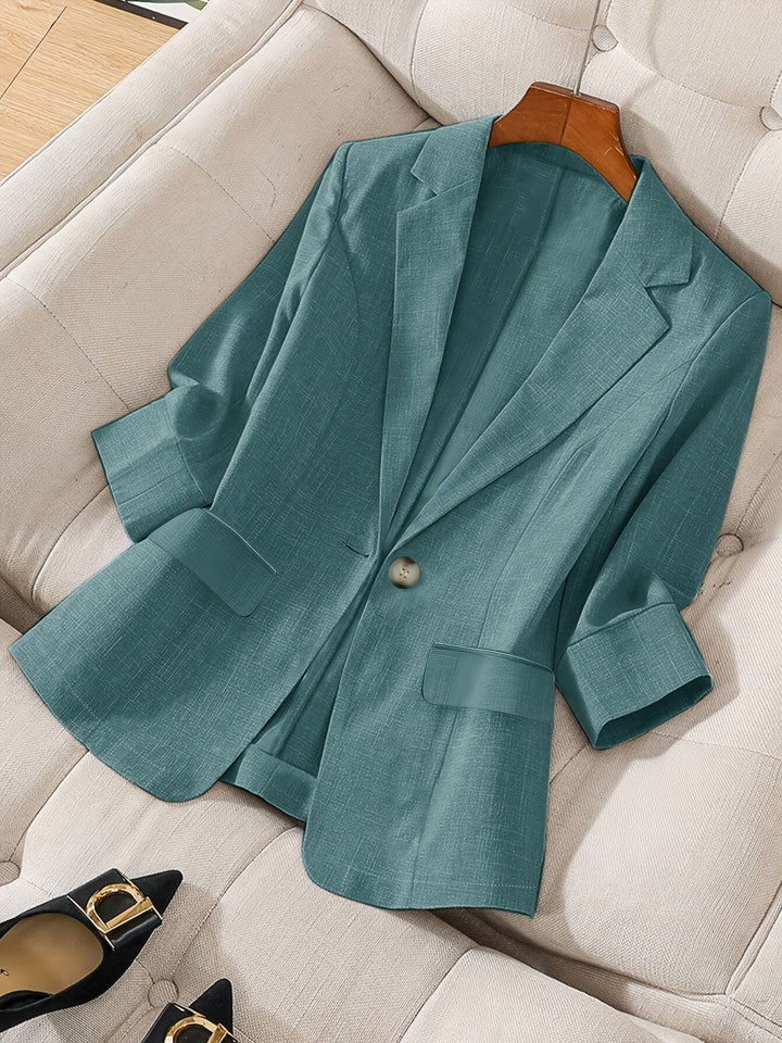 Woman wearing a versatile navy cropped blazer, styled for a chic business casual look.