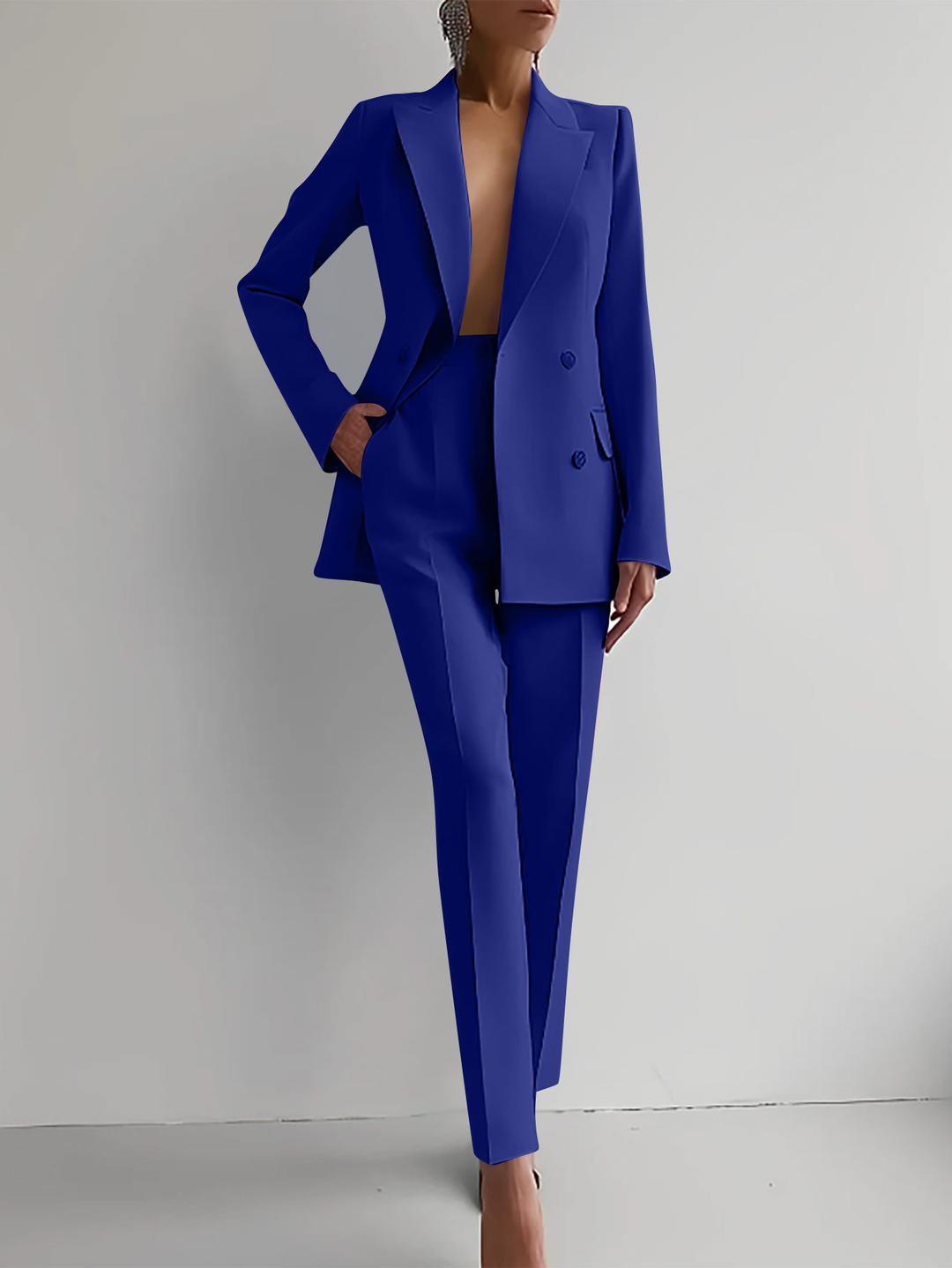 Stylish women's double-breasted blazer and slim trousers suit, perfect for modern business attire.