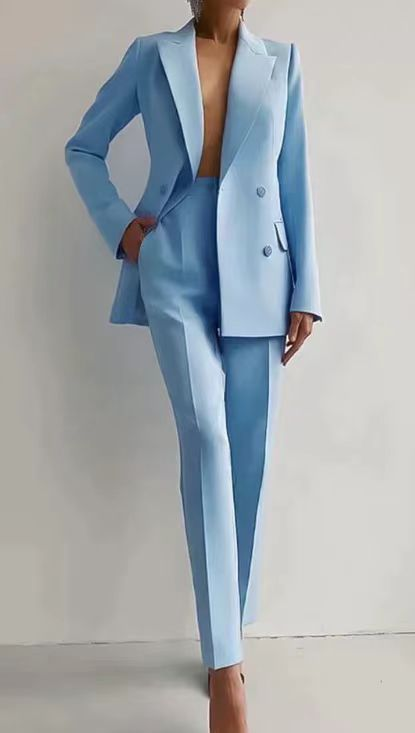 Detail of the high-quality fabric on the women's double-breasted blazer and matching slim trousers.