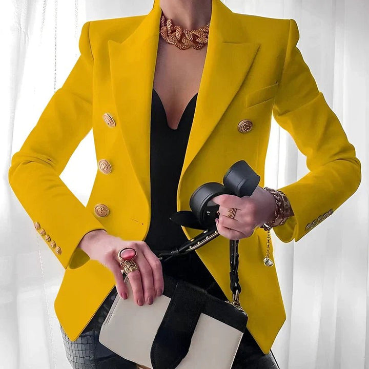 Stylish women's tailored blazer, double-breasted cut with prominent gold buttons, a chic professional look.