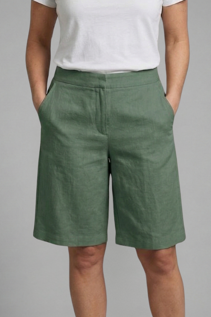 Comfortable women's tailored flat front shorts with slash pockets. Knee-length design for everyday summer versatility.