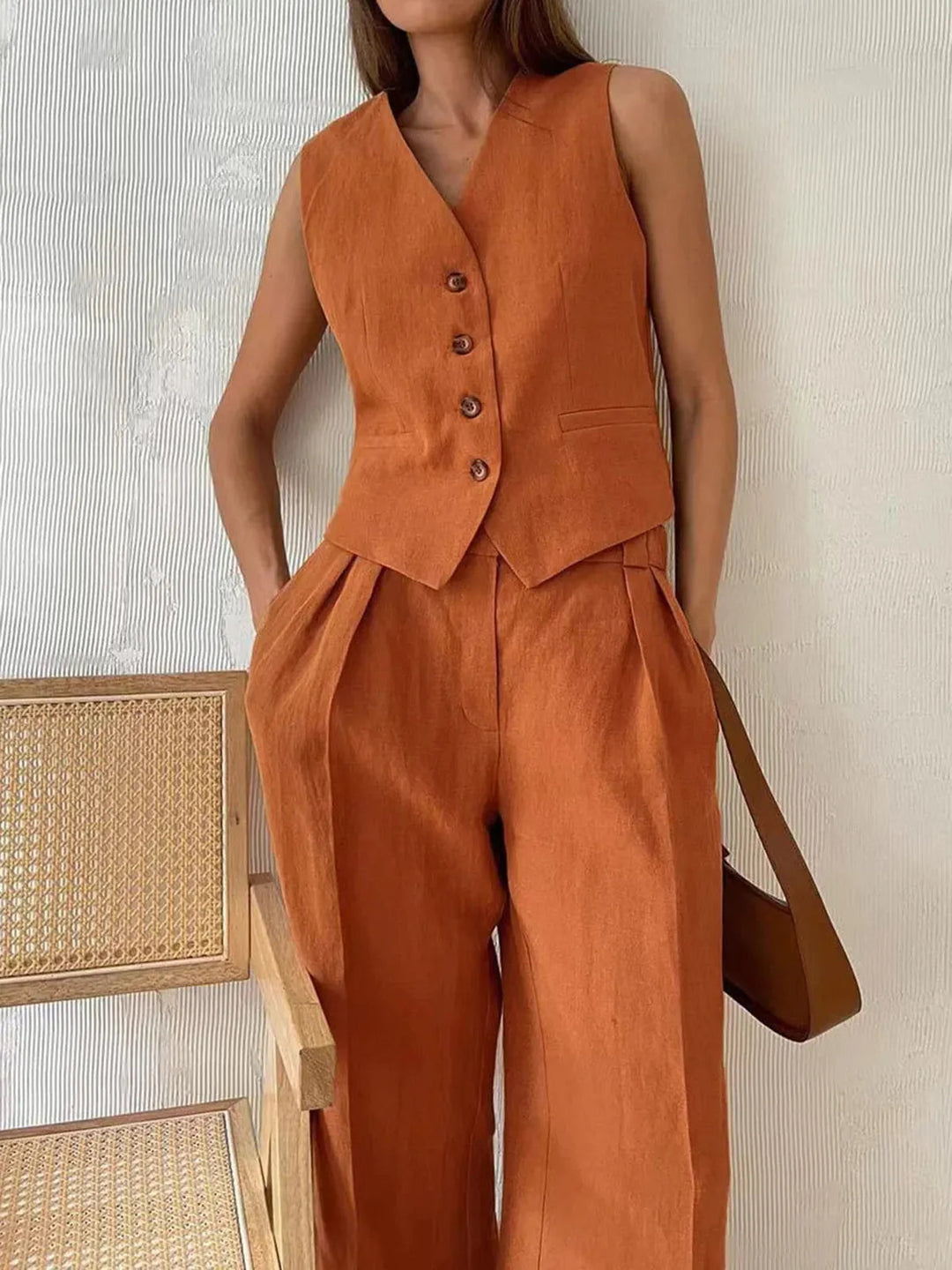 Chic women's matching tailored waistcoat and wide leg trouser set. A versatile two-piece for elegant smart casual fashion.