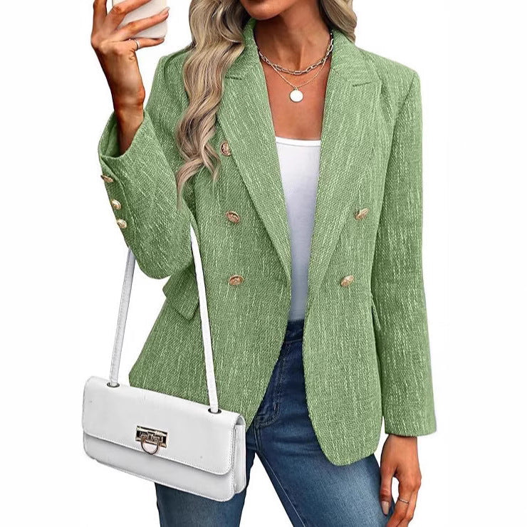 Modern textured women's blazer, double-breasted with sophisticated gold buttons. A contemporary fashion piece.