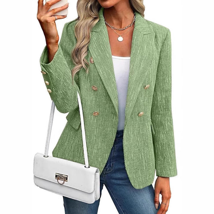 Modern textured women's blazer, double-breasted with sophisticated gold buttons. A contemporary fashion piece.