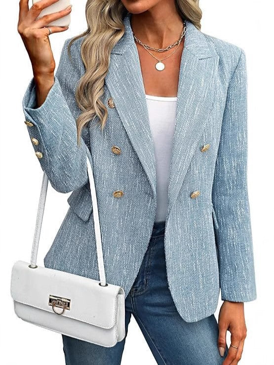 Women's textured blazer highlighting its double-breasted front and striking gold button details. Work to casual.