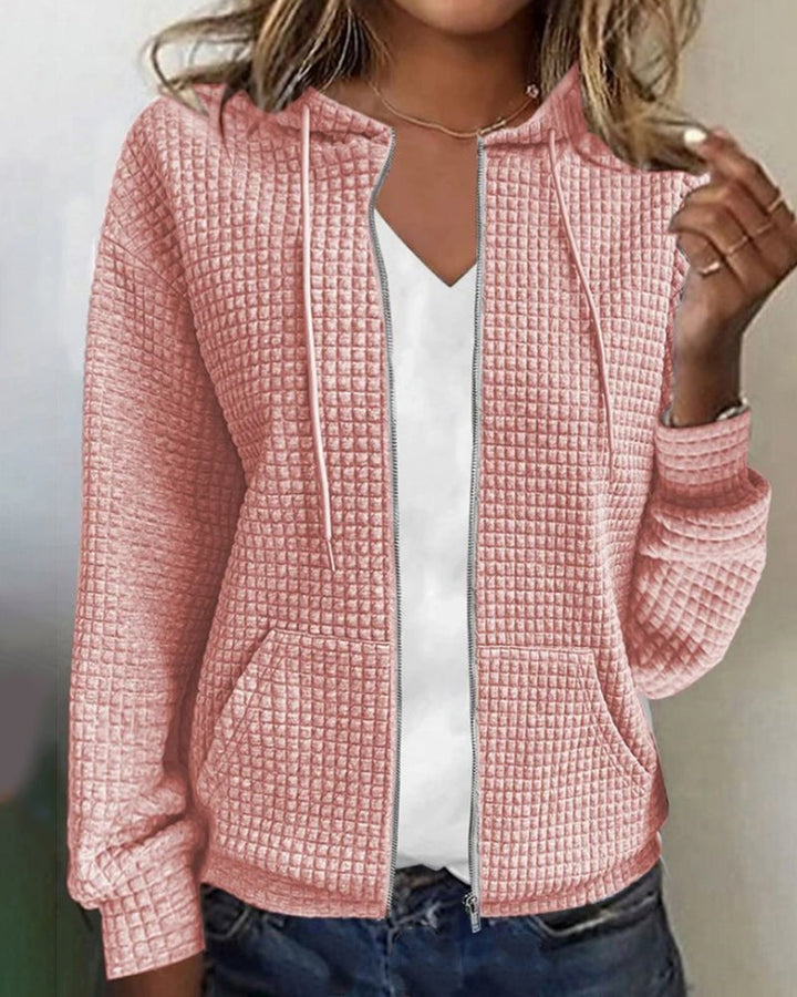 Black women's textured zip-up jacket. Stylish hooded outerwear with front pockets, great for casual wear.