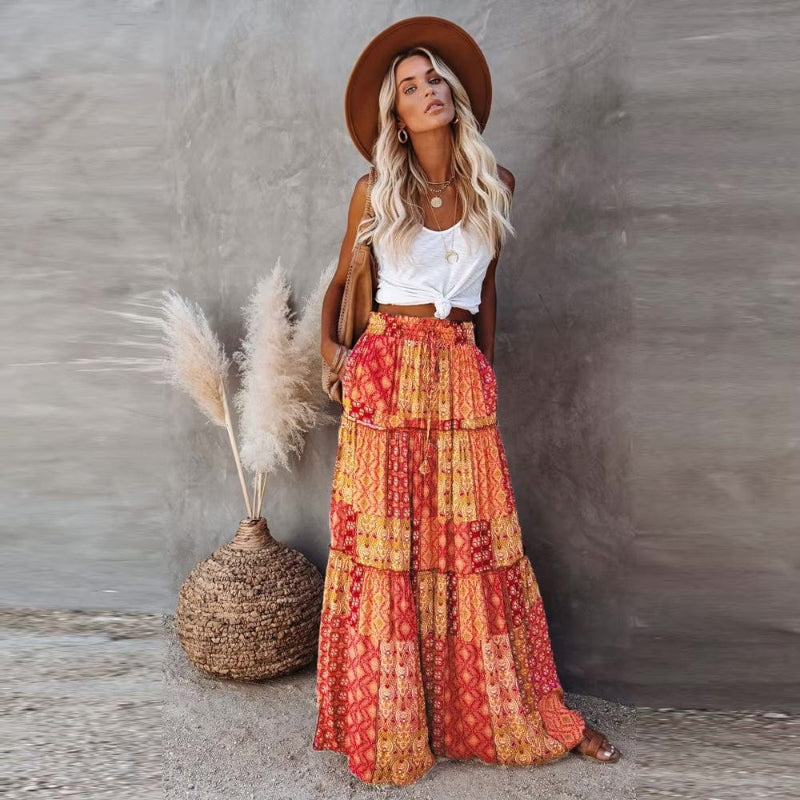 Women's tiered floral maxi skirt with high elastic waist, perfect for summer bohemian style.