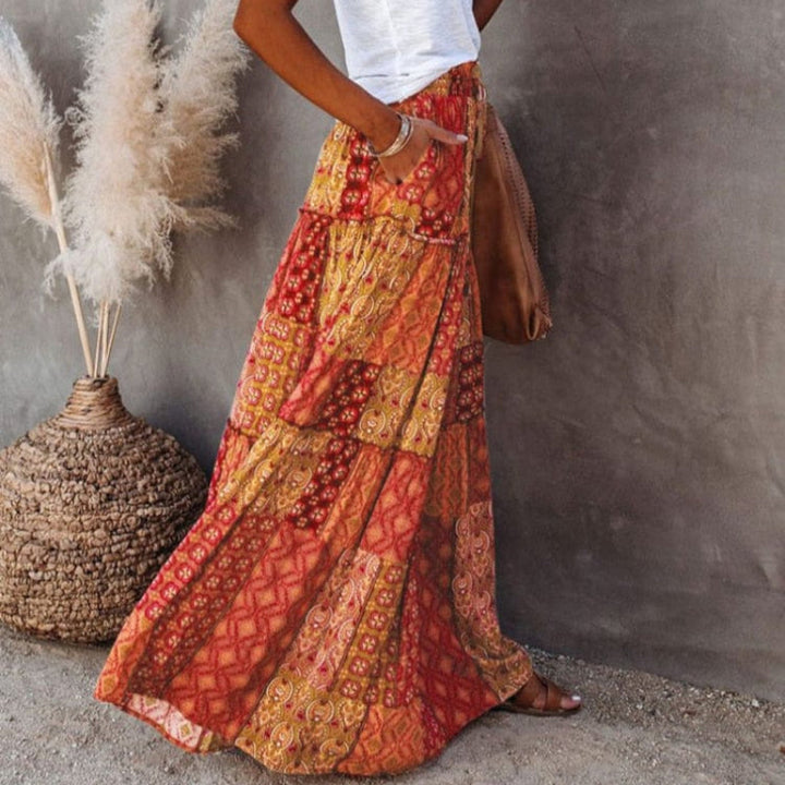 Elegant women's tiered floral maxi skirt with elastic high waist, versatile for summer and casual wear.