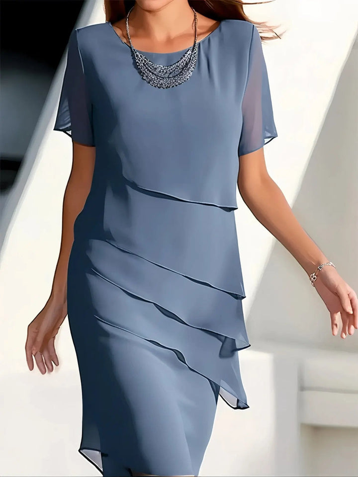 Elegant women's flowing tiered midi dress, perfect for summer or spring. Round neck, short sleeve design for comfort.