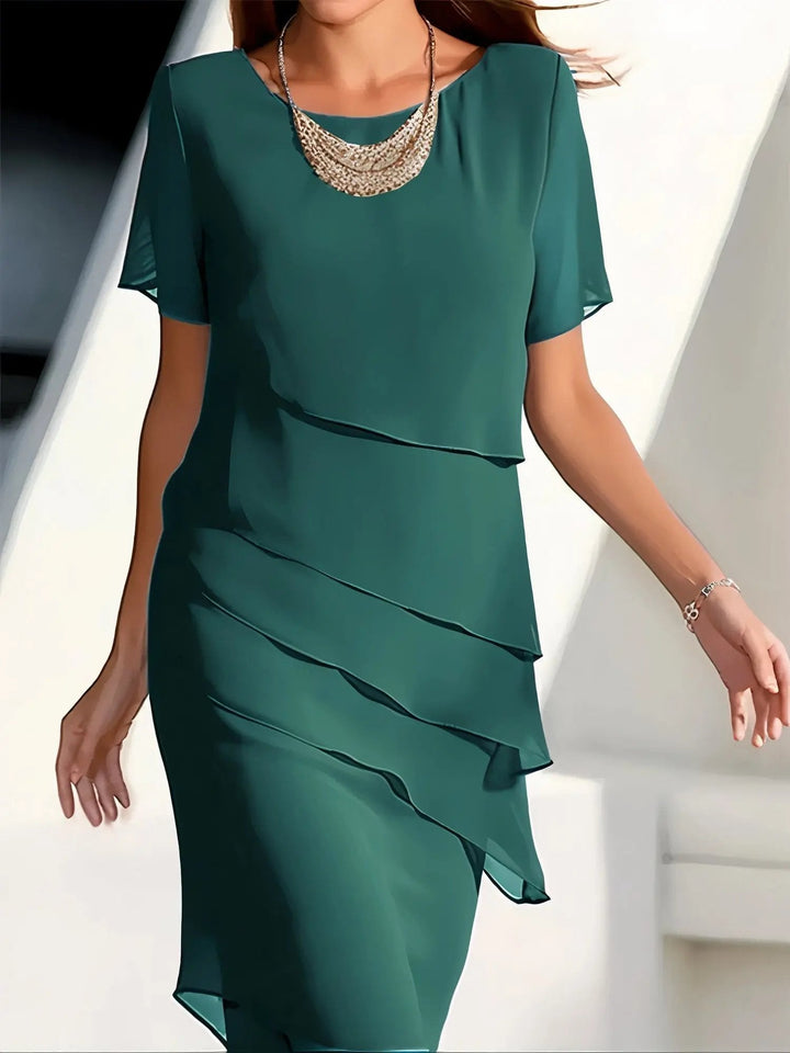 Stylish women's tiered midi dress with a flowing, relaxed fit. Short sleeves and round neck make it versatile for any event.