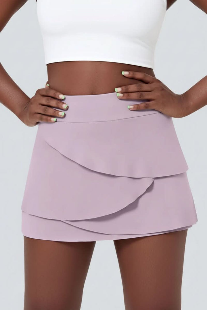 Stylish women's tiered golf skort, perfect for athleisure & active play, featuring convenient side pockets.