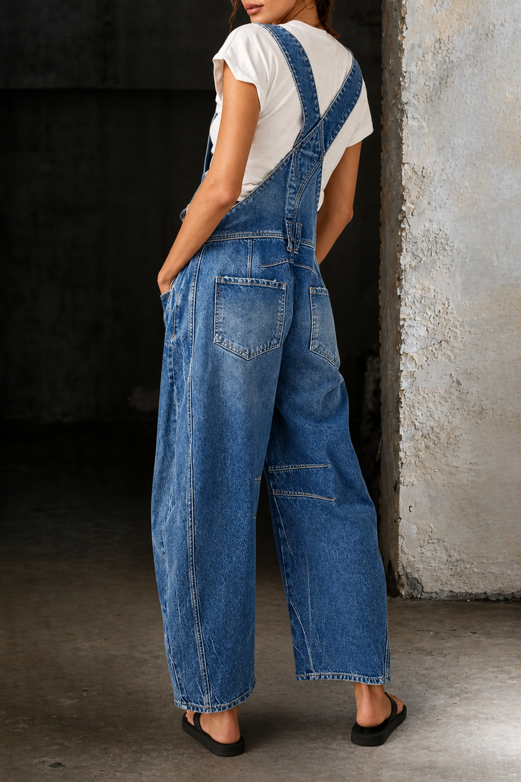 Casual women's distressed denim barrel leg jumpsuit. Baggy, relaxed fit perfect for street style with functional pockets.